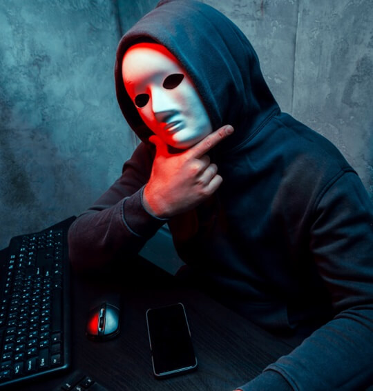 Computer hacker with mask on
